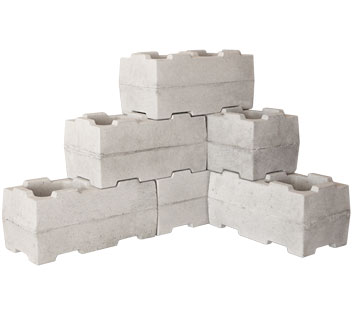 A Stumbelbloc mould alongside a finished interlocking concrete block